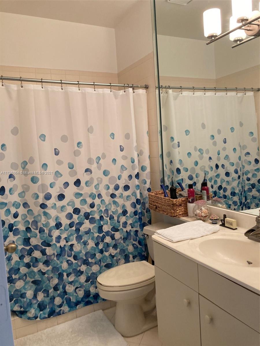 6765 Montego Bay Boulevard, Unit E Boca Raton, FL 33433 - Photo 11 of 31 a bathroom with a sink toilet and shower