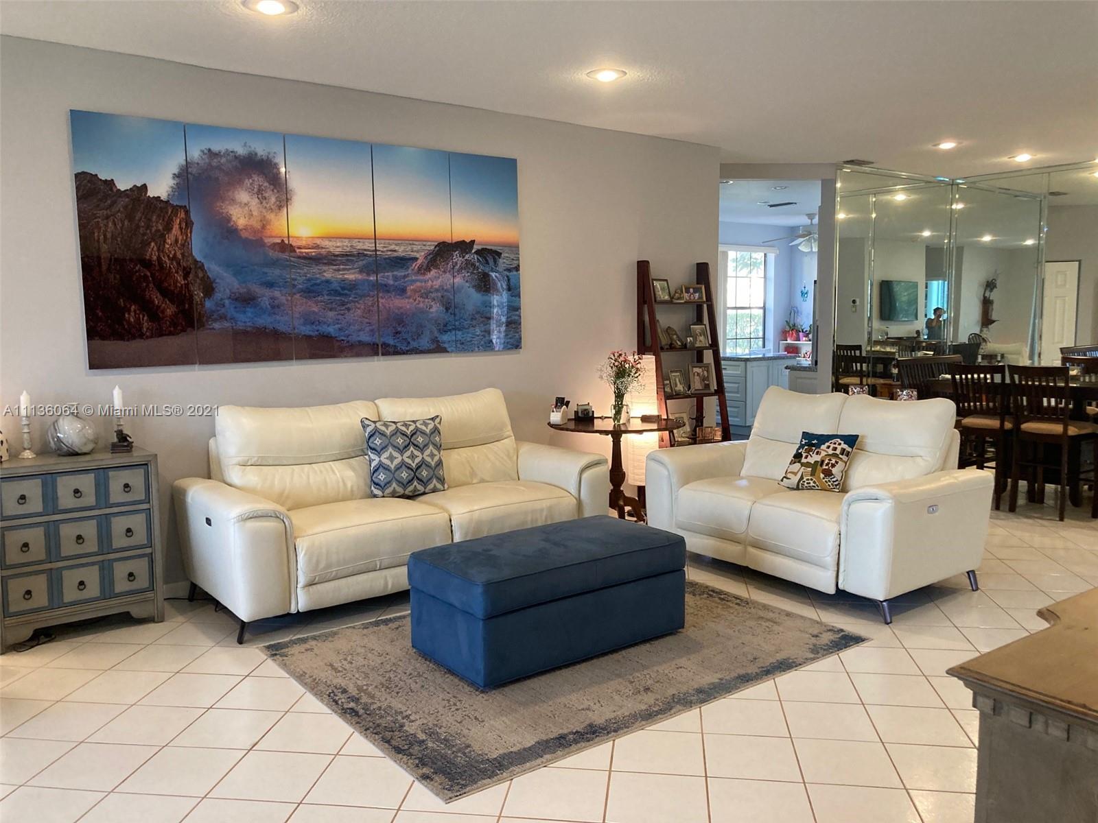 6765 Montego Bay Boulevard, Unit E Boca Raton, FL 33433 - Photo 16 of 31 a living room with furniture and a lamp