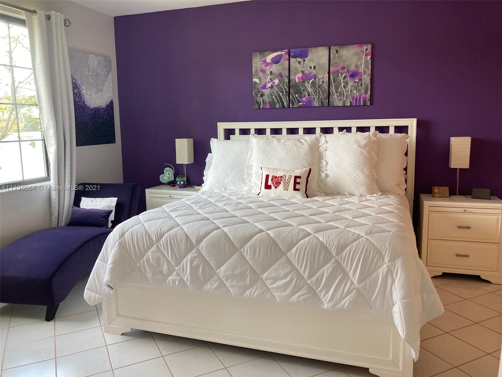 6765 Montego Bay Boulevard, Unit E Boca Raton, FL 33433 - Photo 17 of 31 a bedroom with a bed and a painting on the wall