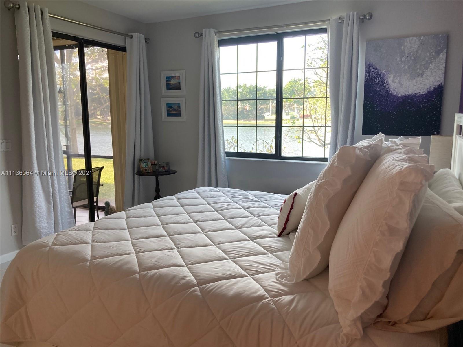 6765 Montego Bay Boulevard, Unit E Boca Raton, FL 33433 - Photo 18 of 31 a bedroom with a bed and window