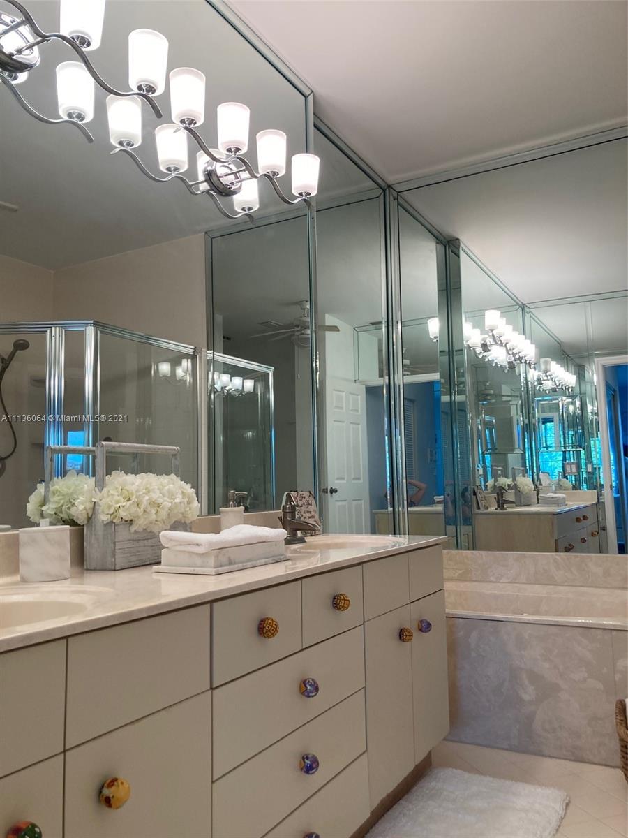 6765 Montego Bay Boulevard, Unit E Boca Raton, FL 33433 - Photo 21 of 31 a bathroom with a double vanity sink and a mirror