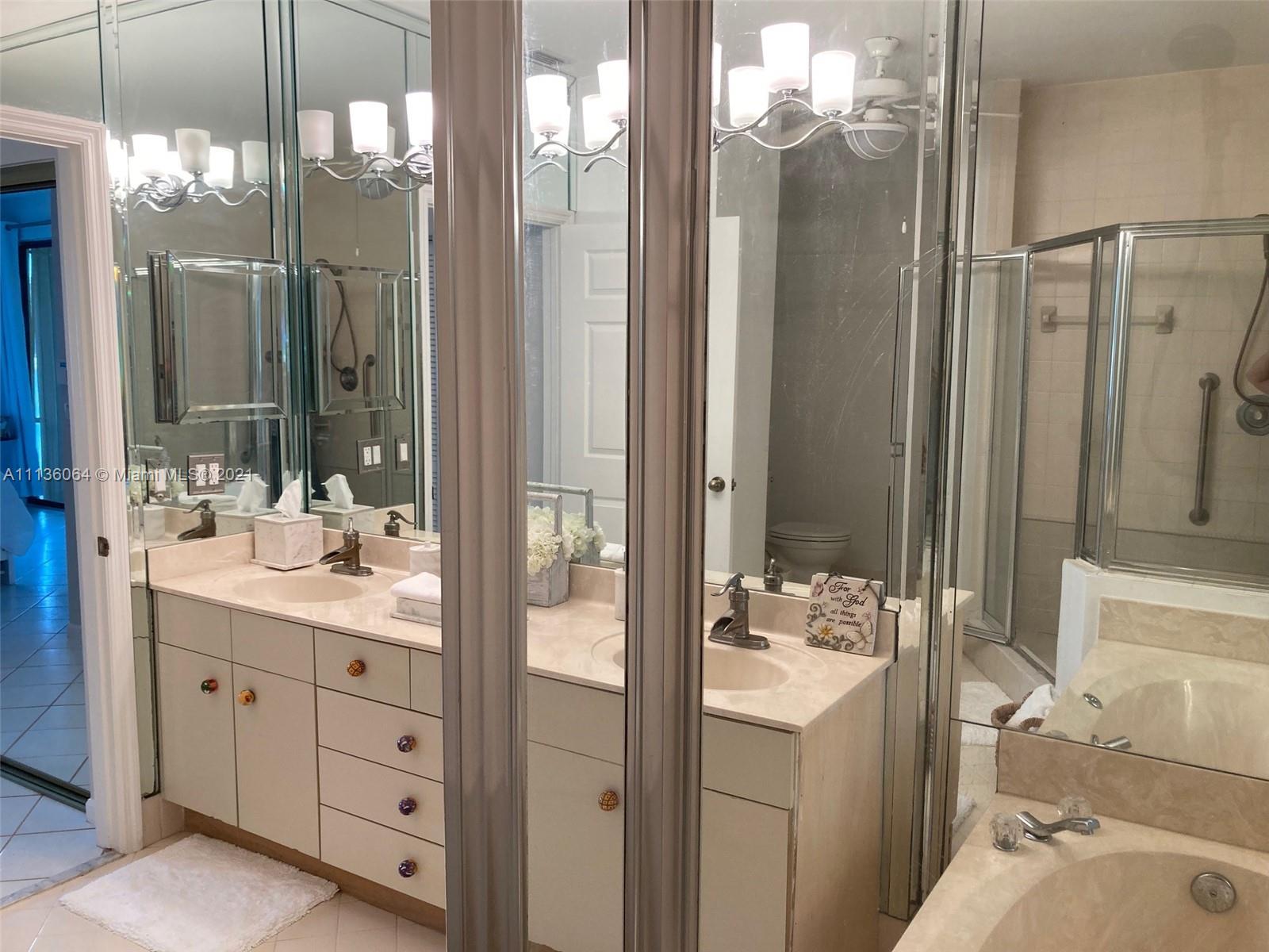 6765 Montego Bay Boulevard, Unit E Boca Raton, FL 33433 - Photo 23 of 31 a bathroom with a double vanity sink mirror and shower