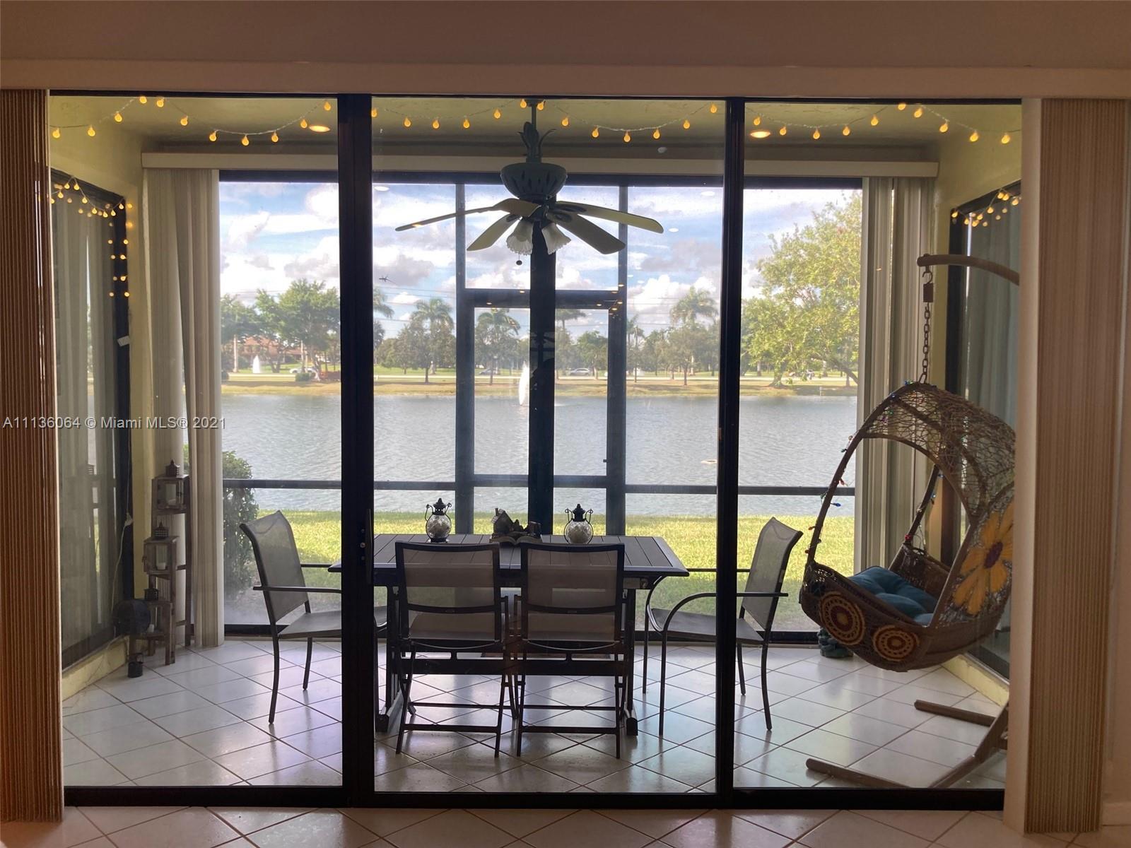 6765 Montego Bay Boulevard, Unit E Boca Raton, FL 33433 - Photo 24 of 31 a view of a chairs and table in the balcony