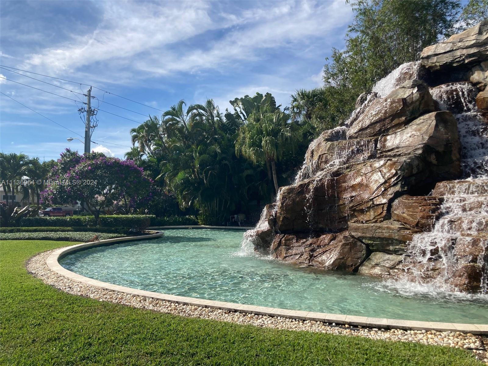 6765 Montego Bay Boulevard, Unit E Boca Raton, FL 33433 - Photo 28 of 31 a view of a swimming pool with a yard