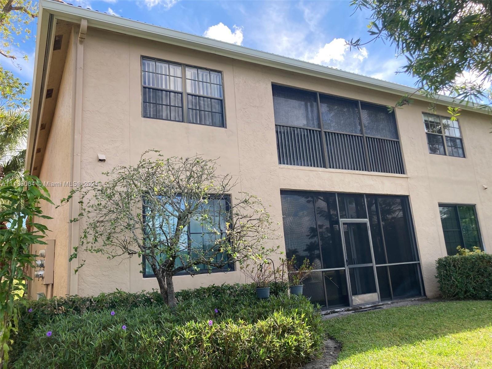 6765 Montego Bay Boulevard, Unit E Boca Raton, FL 33433 - Photo 4 of 31 a front view of a house with a yard