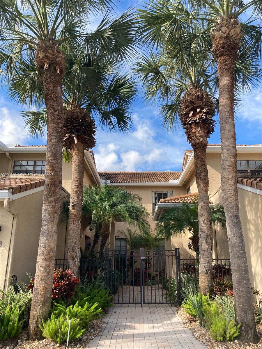 6765 Montego Bay Boulevard, Unit E Boca Raton, FL 33433 - Photo 6 of 31 a couple of palm trees sitting in front of a house