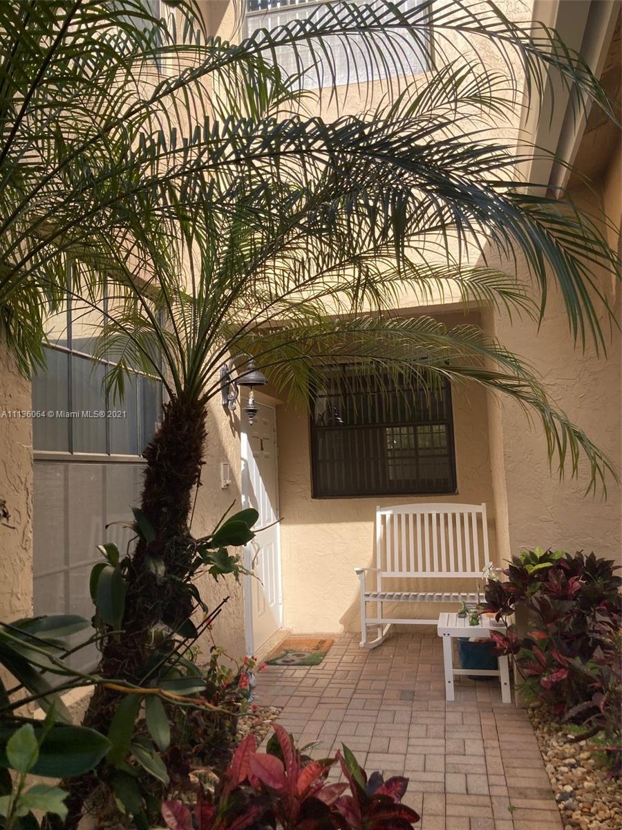 6765 Montego Bay Boulevard, Unit E Boca Raton, FL 33433 - Photo 7 of 31 a view of a bench in the backyard