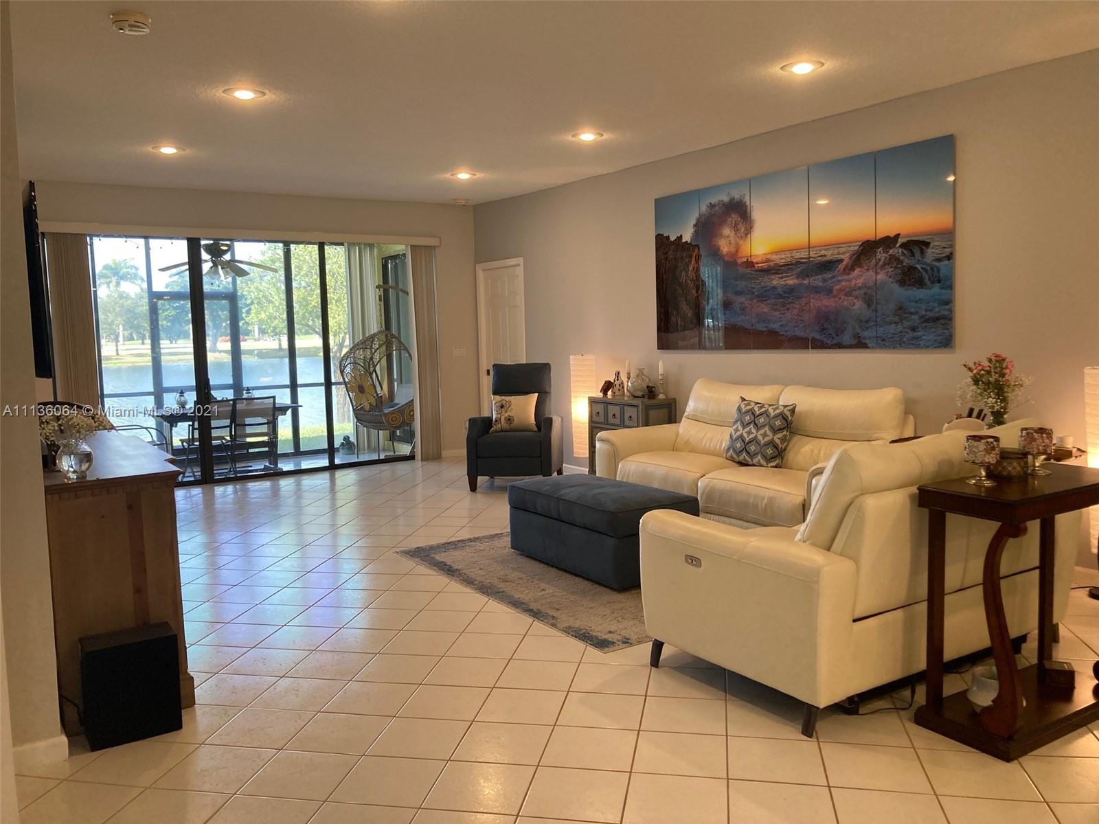 6765 Montego Bay Boulevard, Unit E Boca Raton, FL 33433 - Photo 8 of 31 a living room with furniture and a large window