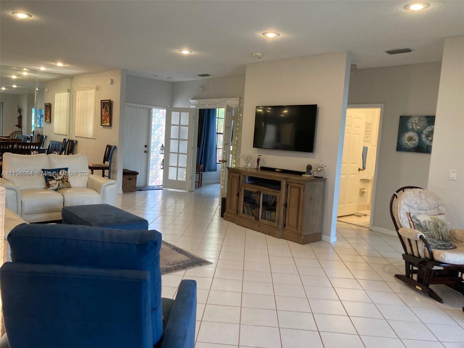 6765 Montego Bay Boulevard, Unit E Boca Raton, FL 33433 - Photo 9 of 31 a living room with furniture and a flat screen tv