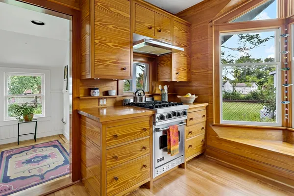a kitchen with stainless steel appliances granite countertop a stove and a window