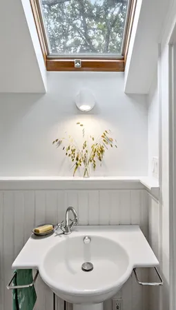 a bathroom with a sink and a window