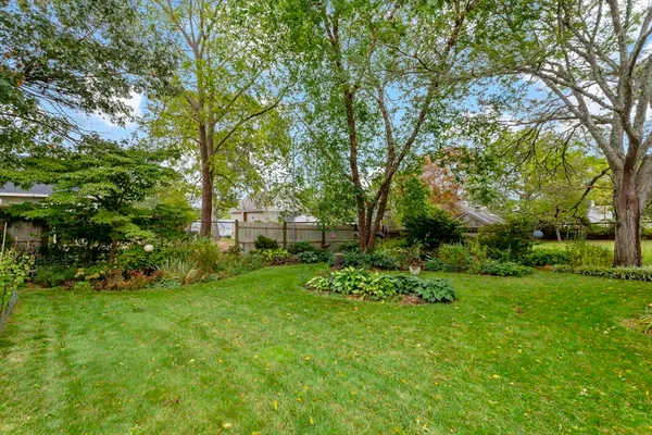 a view of backyard of house with green space