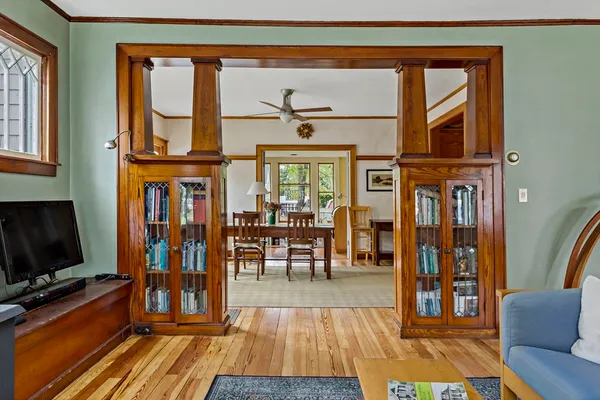 a living room with furniture a flat screen tv and a floor to ceiling window