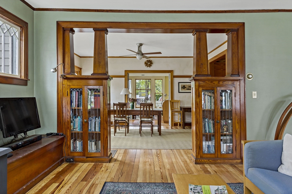 34 Washington Bourne, MA 02532 - Photo 5 of 34 a living room with furniture a flat screen tv and a floor to ceiling window