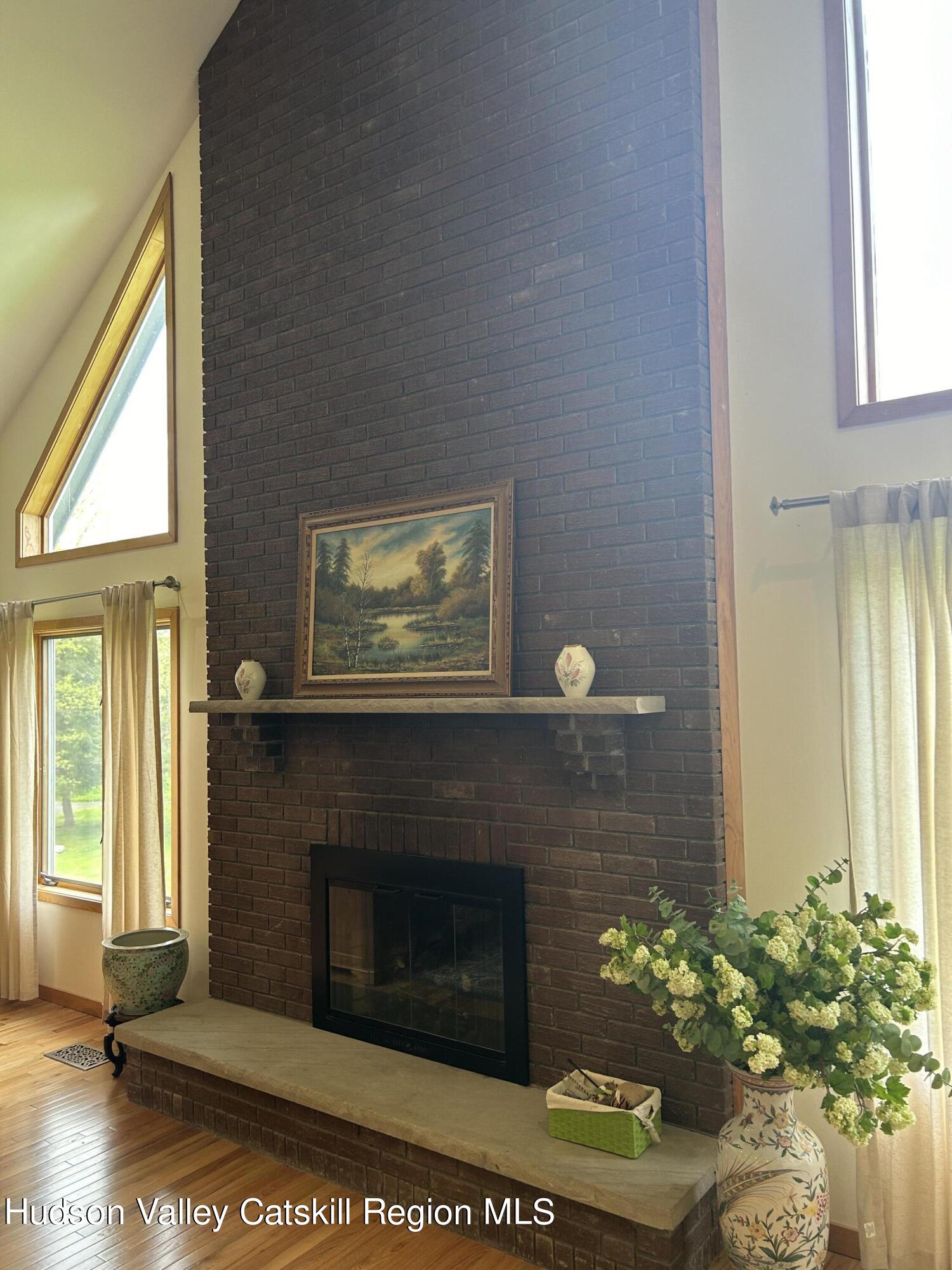 40 Tillson Lake Road Wallkill, NY 12589 - Photo 13 of 42 a living room with a fireplace and a window