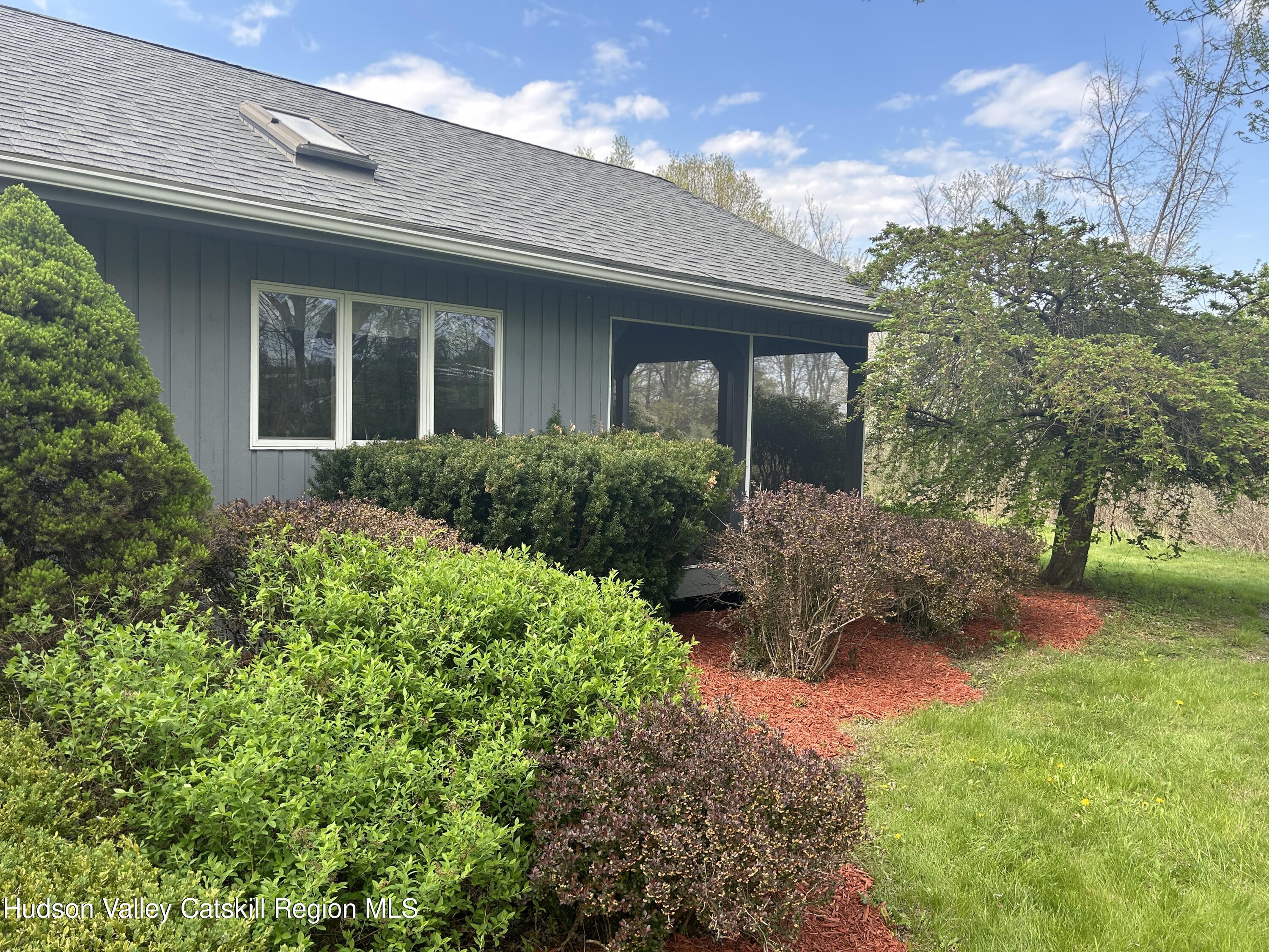 40 Tillson Lake Road Wallkill, NY 12589 - Photo 5 of 42 a front view of a house with a yard and potted plants