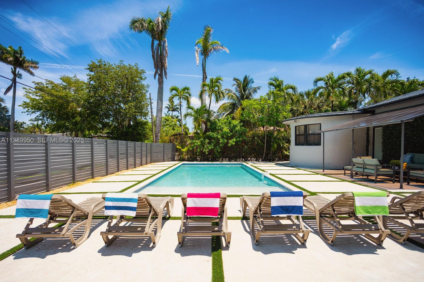 a backyard of a house with table and chairs