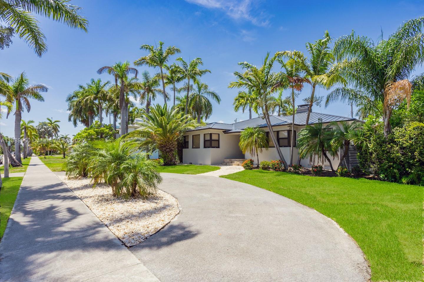 801 Harrison Street Hollywood, FL 33019 - Photo 13 of 46 a front view of a house with a yard and potted plants