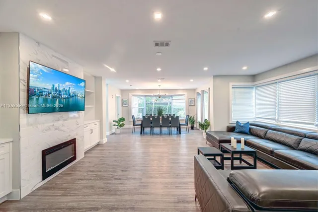 a living room with fireplace furniture and a flat screen tv