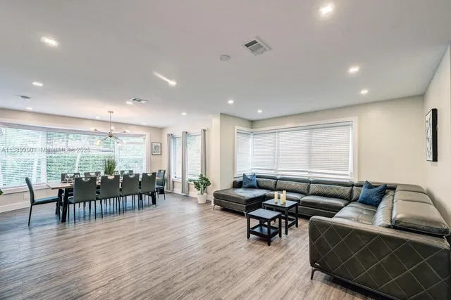 a living room with lots of furniture and wooden floor