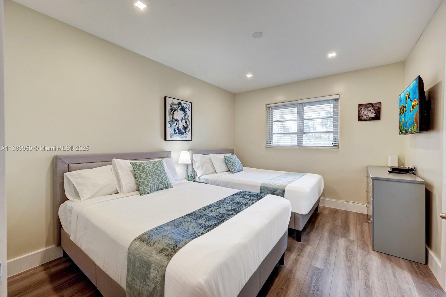 801 Harrison Street Hollywood, FL 33019 - Photo 21 of 46 a bed room with bed and a flat screen tv