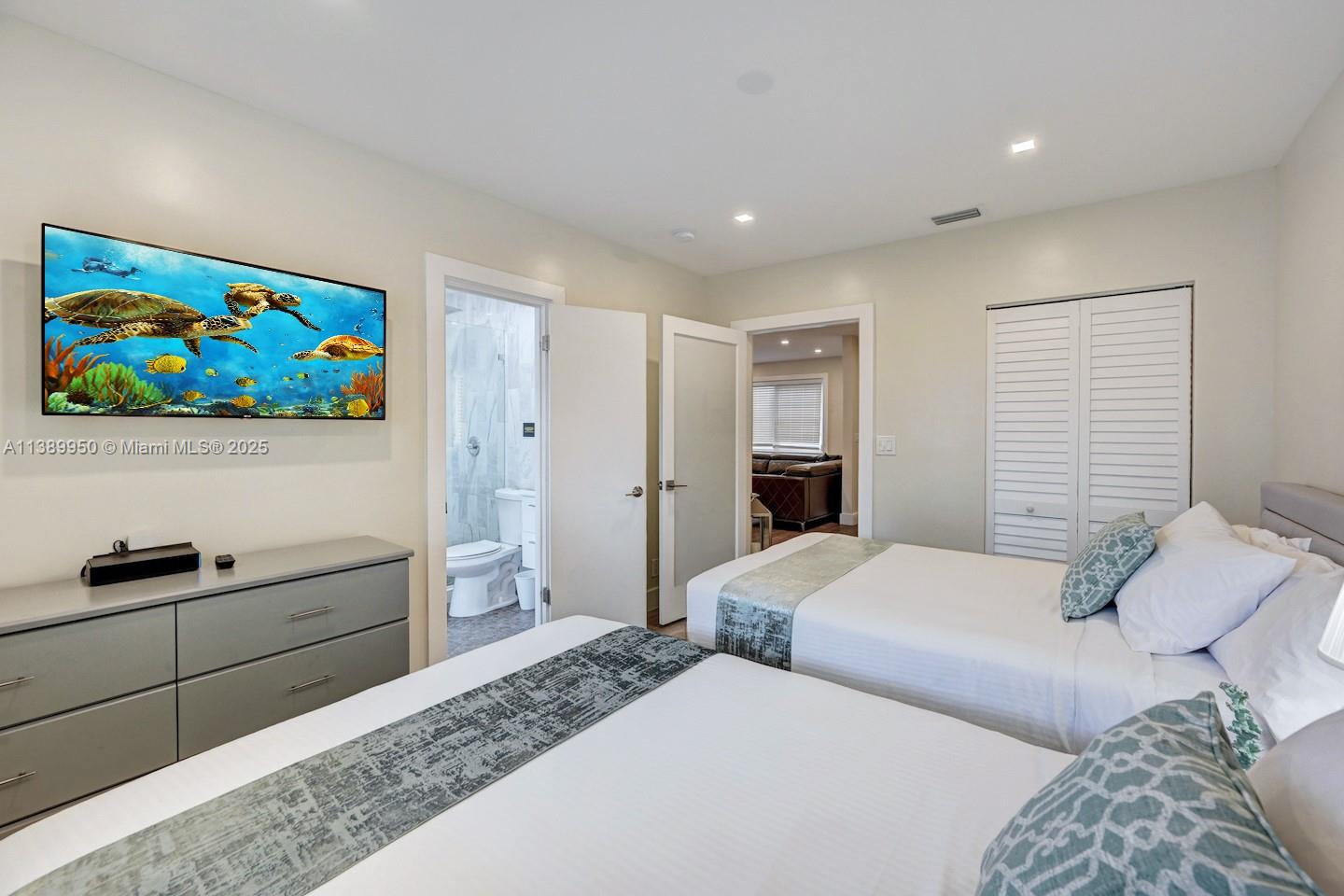 801 Harrison Street Hollywood, FL 33019 - Photo 22 of 46 a bedroom with a bed and a cabinet