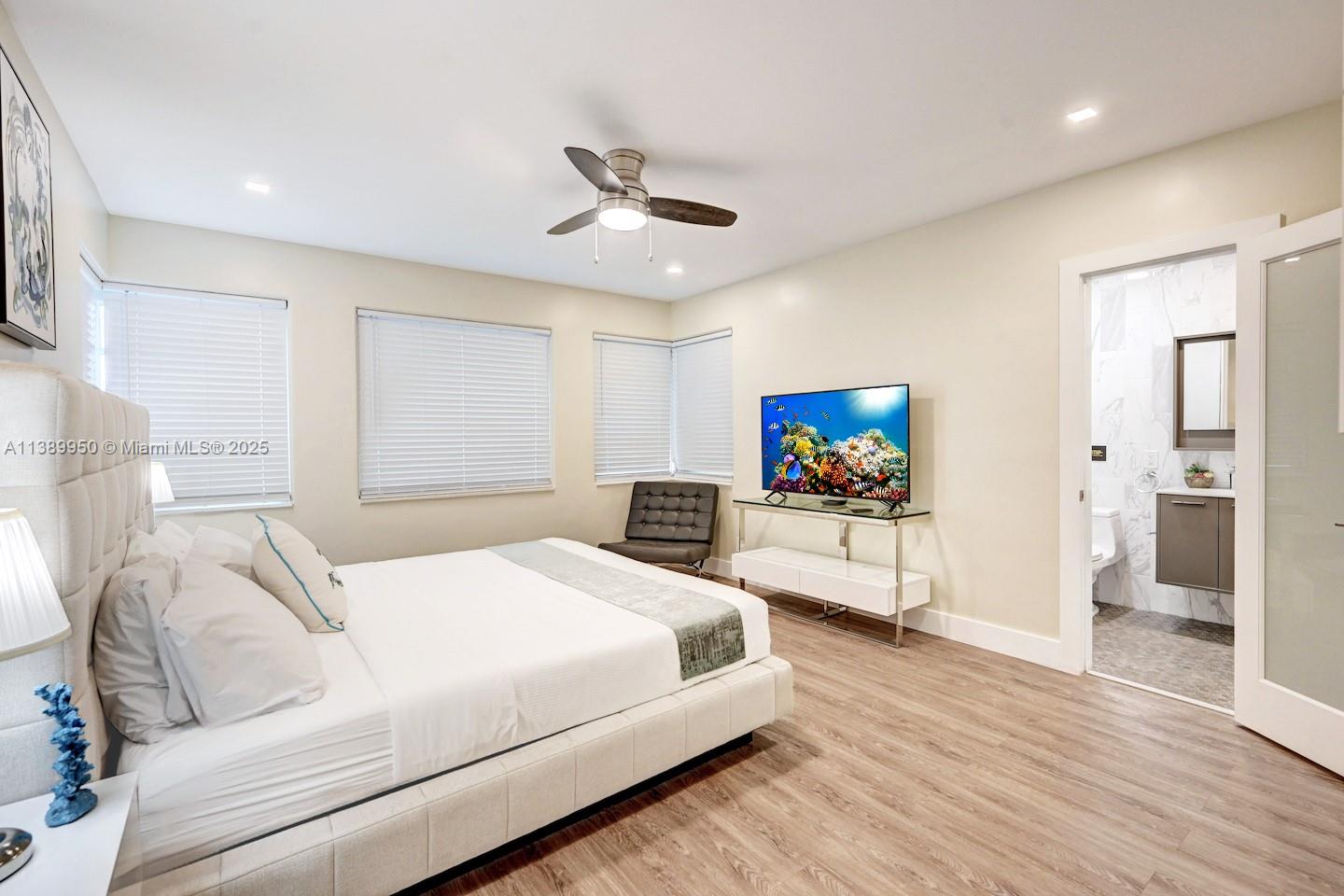 801 Harrison Street Hollywood, FL 33019 - Photo 24 of 46 a bedroom with a bed and a flat screen tv