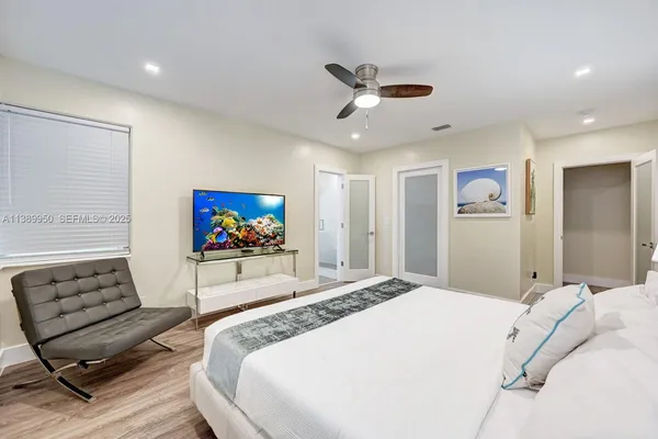 a bedroom with a bed and a chair