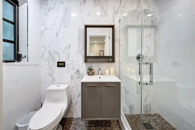 a bathroom with a sink toilet and shower