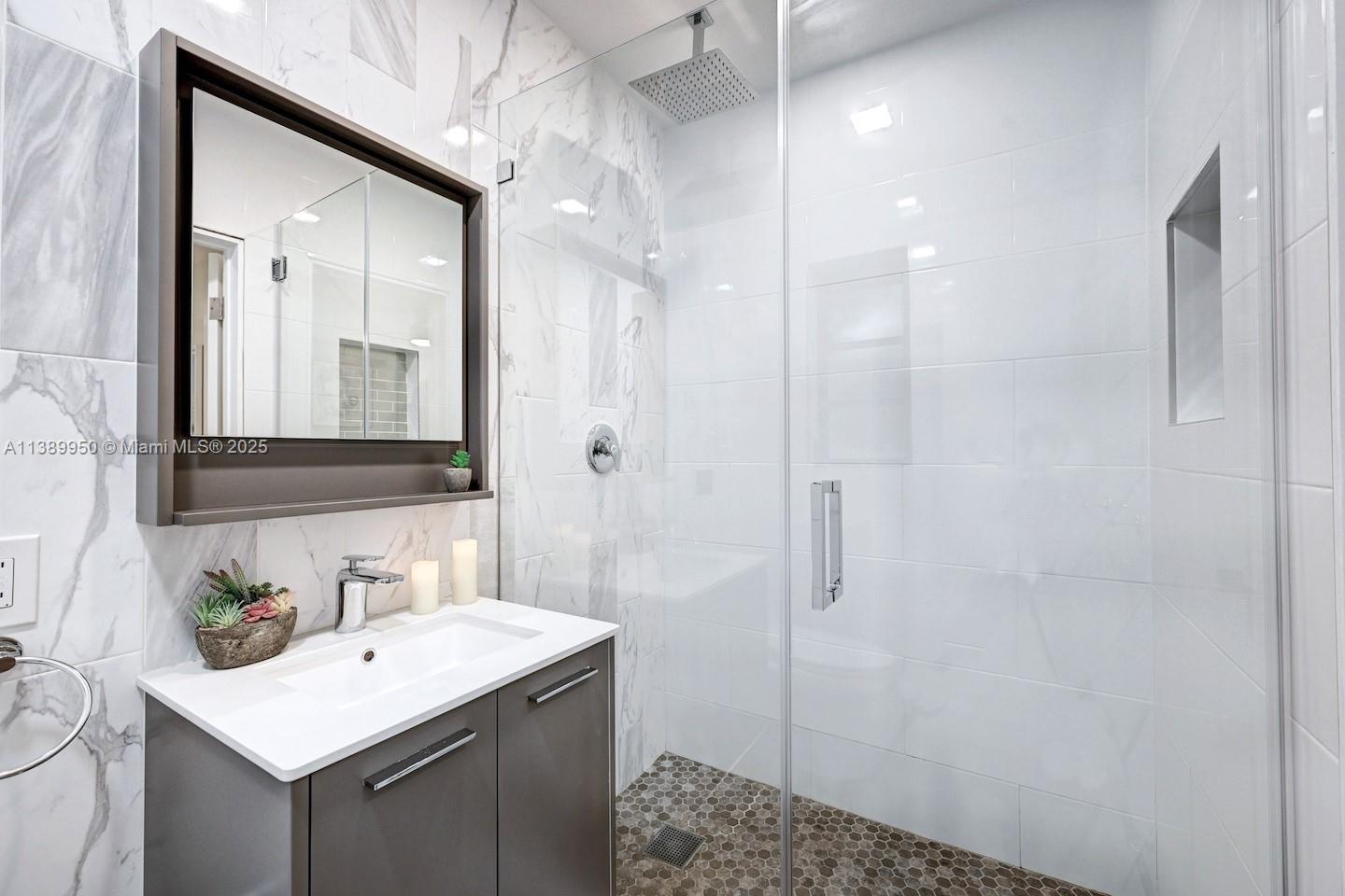 801 Harrison Street Hollywood, FL 33019 - Photo 28 of 46 a bathroom with a sink a toilet a shower and a mirror