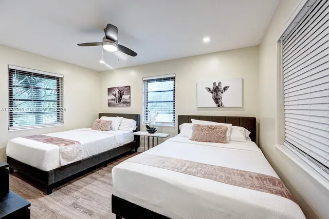 a bedroom with two beds and a window