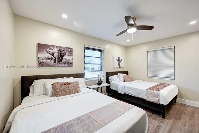 a bedroom with two beds and painting on the wall