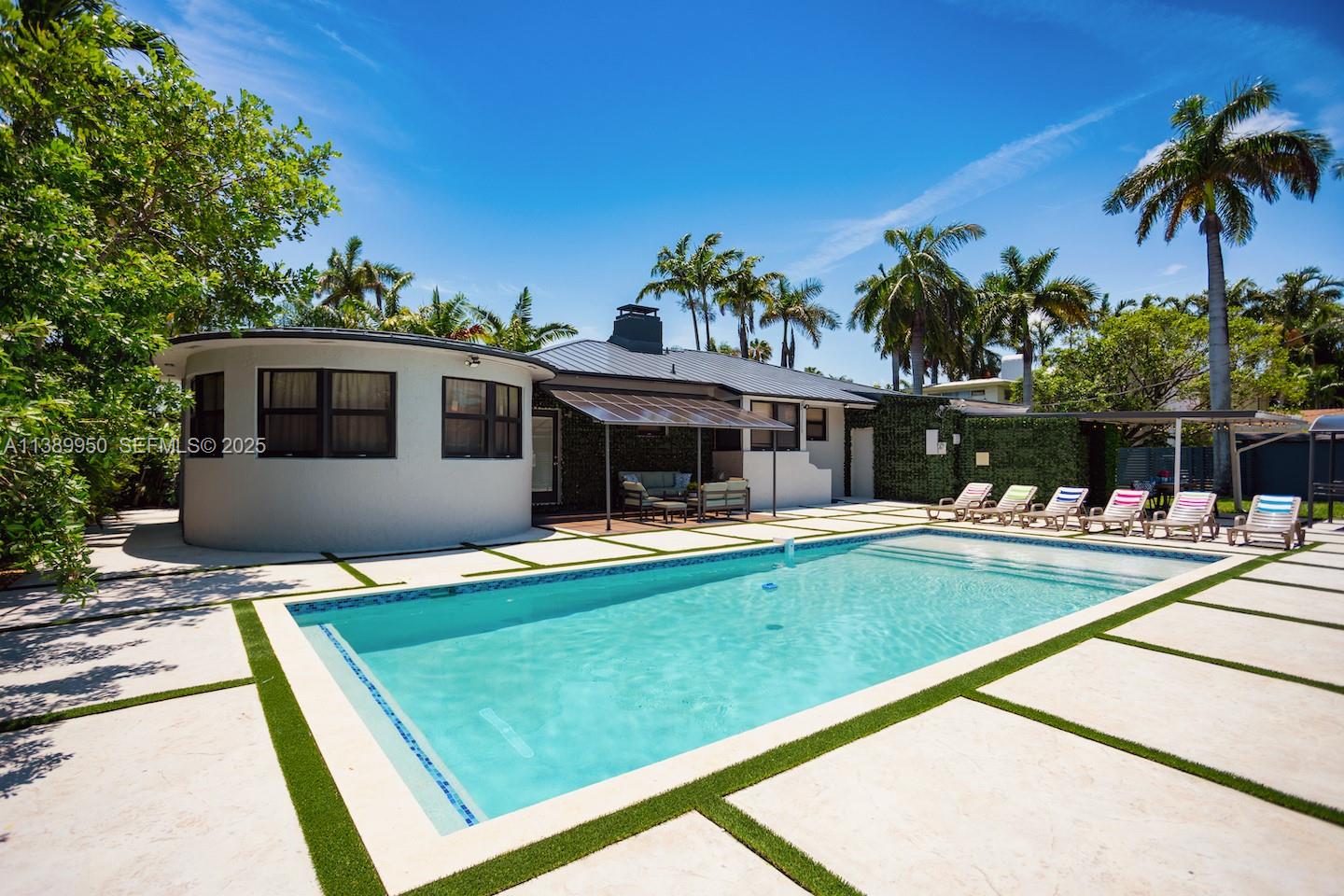 801 Harrison Street Hollywood, FL 33019 - Photo 3 of 46 a view of house with swimming pool and outdoor seating