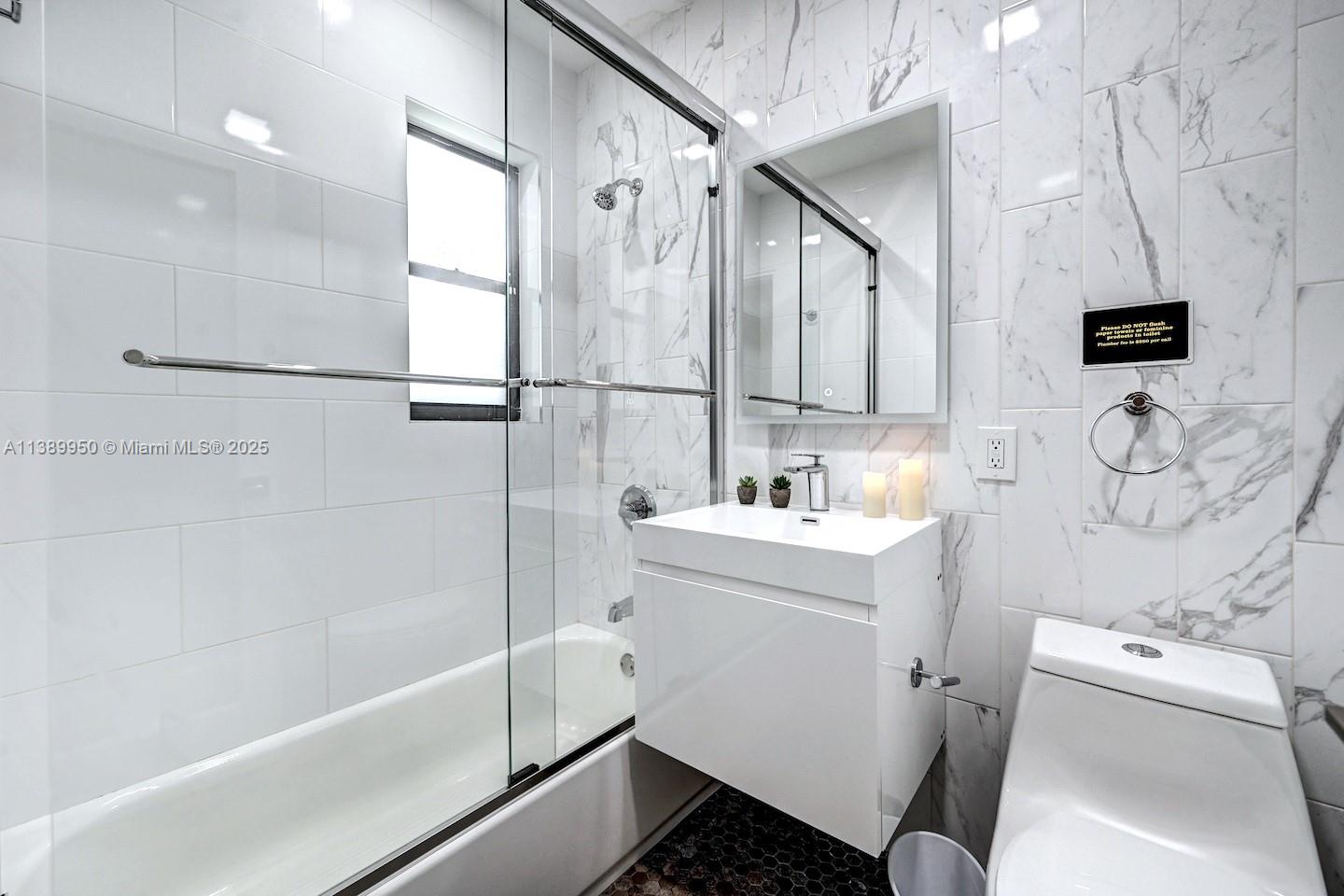 801 Harrison Street Hollywood, FL 33019 - Photo 33 of 46 a bathroom with a sink toilet and shower