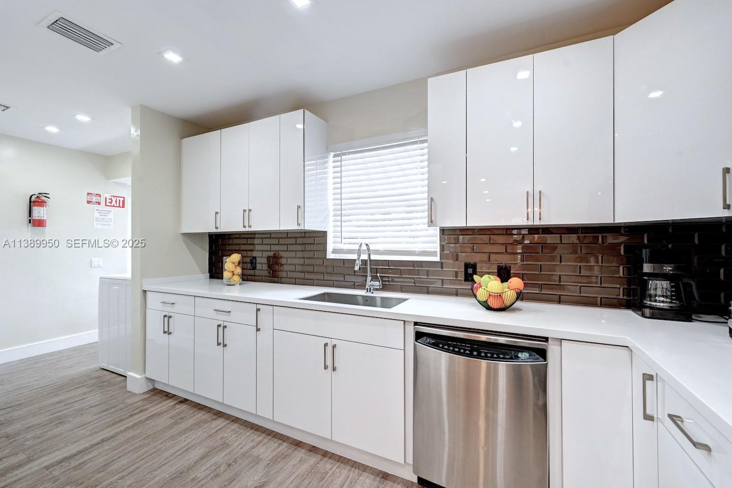 801 Harrison Street Hollywood, FL 33019 - Photo 35 of 46 a kitchen with stainless steel appliances granite countertop a sink stove and cabinets