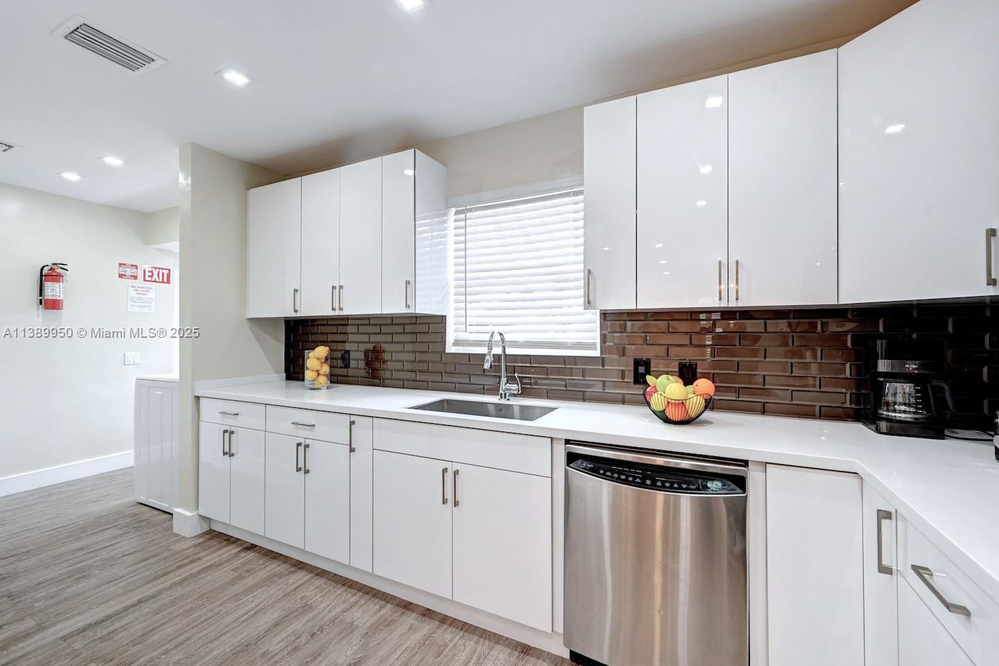 801 Harrison Street Hollywood, FL 33019 - Photo 35 of 46 a kitchen with stainless steel appliances granite countertop a sink stove and cabinets