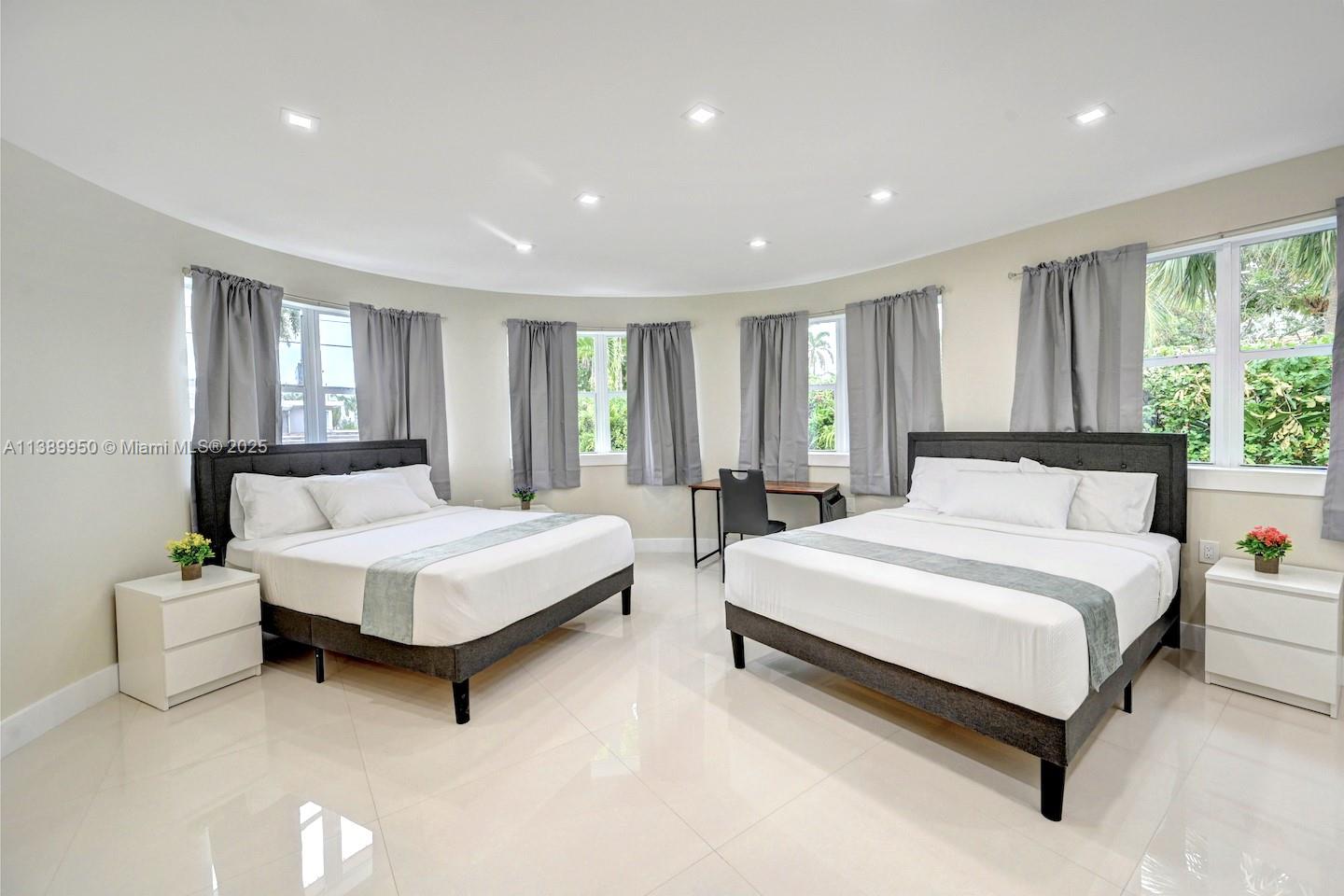 801 Harrison Street Hollywood, FL 33019 - Photo 39 of 46 a spacious bedroom with a bed and large windows