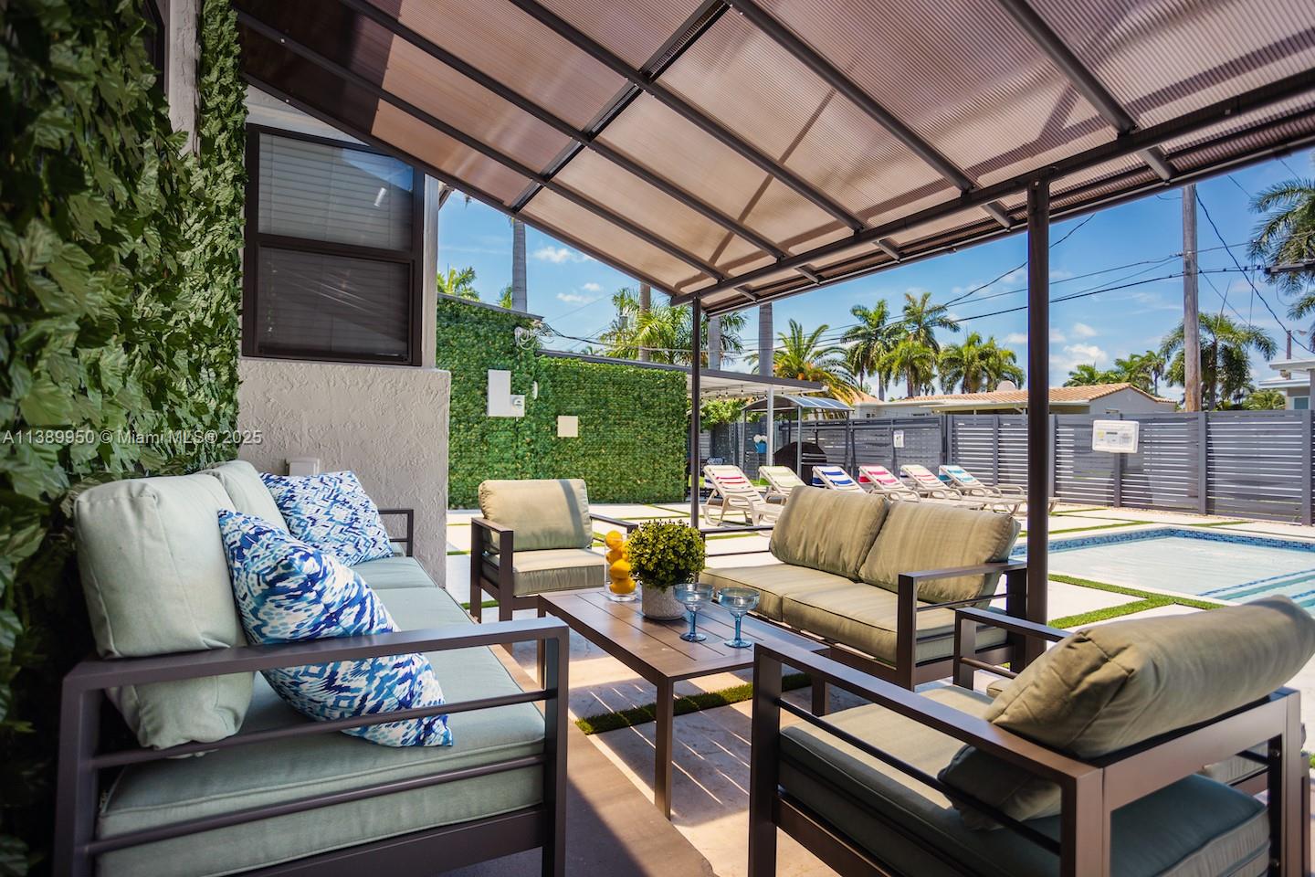 801 Harrison Street Hollywood, FL 33019 - Photo 5 of 46 a view of a patio with couches chairs and a table and chairs