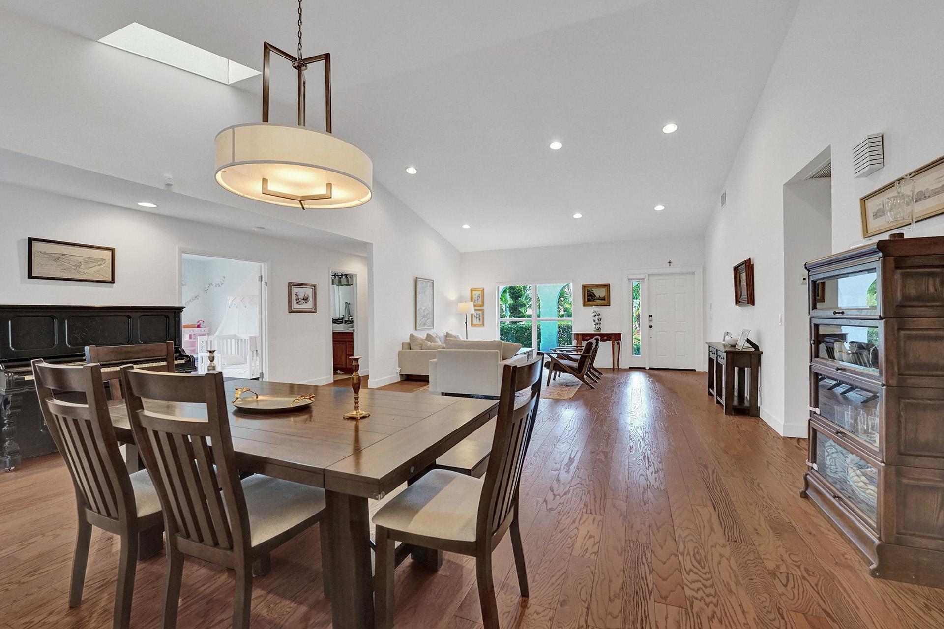 5264 Deerhurst Crescent Circle Boca Raton, FL 33486 - Photo 14 of 62 a view of a dining room with furniture wooden floor and chandelier
