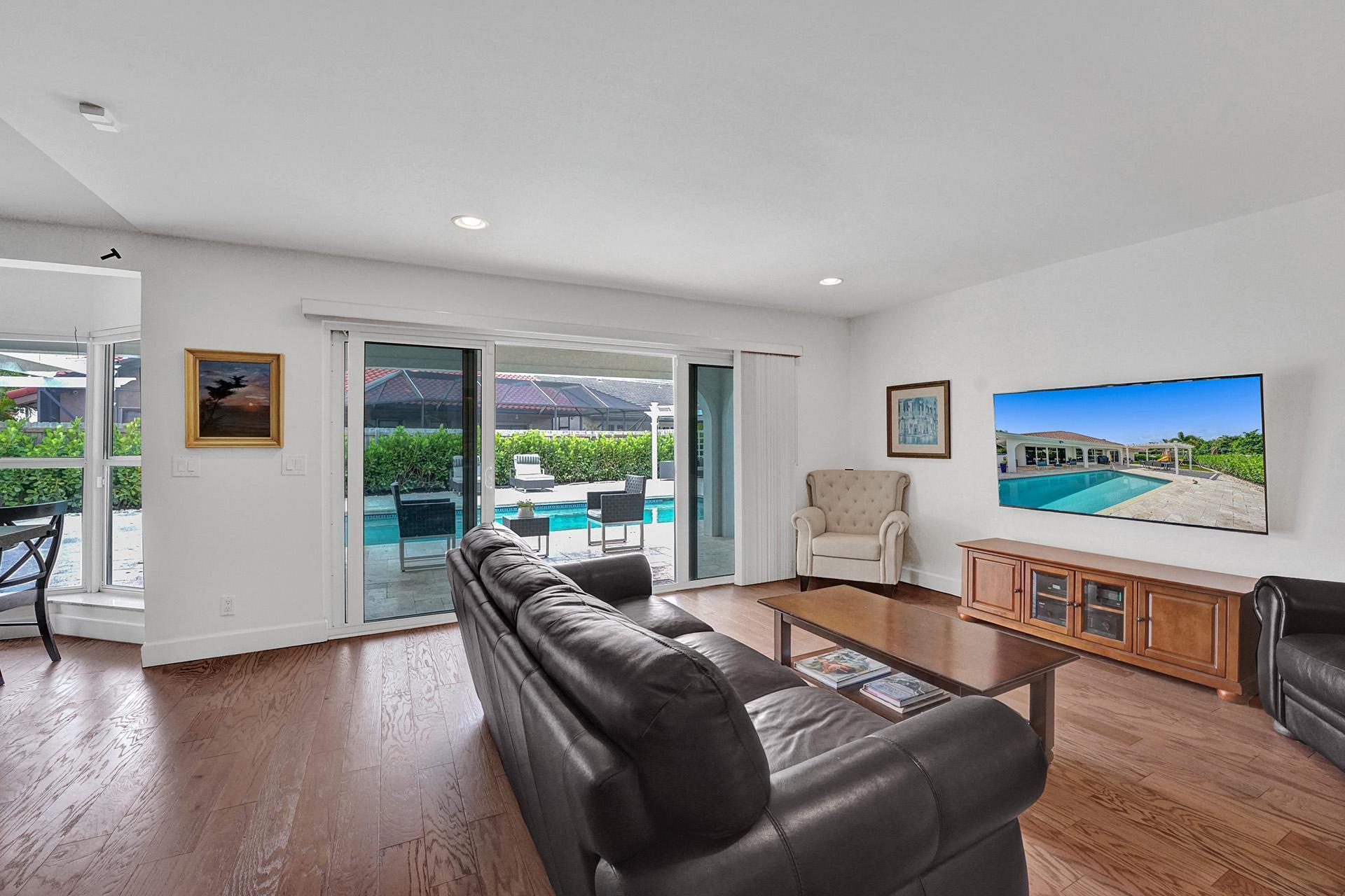 5264 Deerhurst Crescent Circle Boca Raton, FL 33486 - Photo 19 of 62 a living room with furniture and a flat screen tv