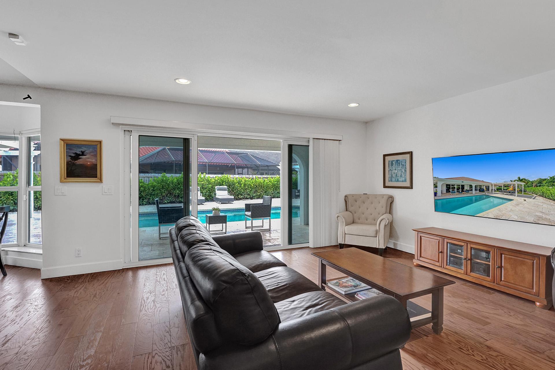 5264 Deerhurst Crescent Circle Boca Raton, FL 33486 - Photo 23 of 62 a living room with furniture and a flat screen tv