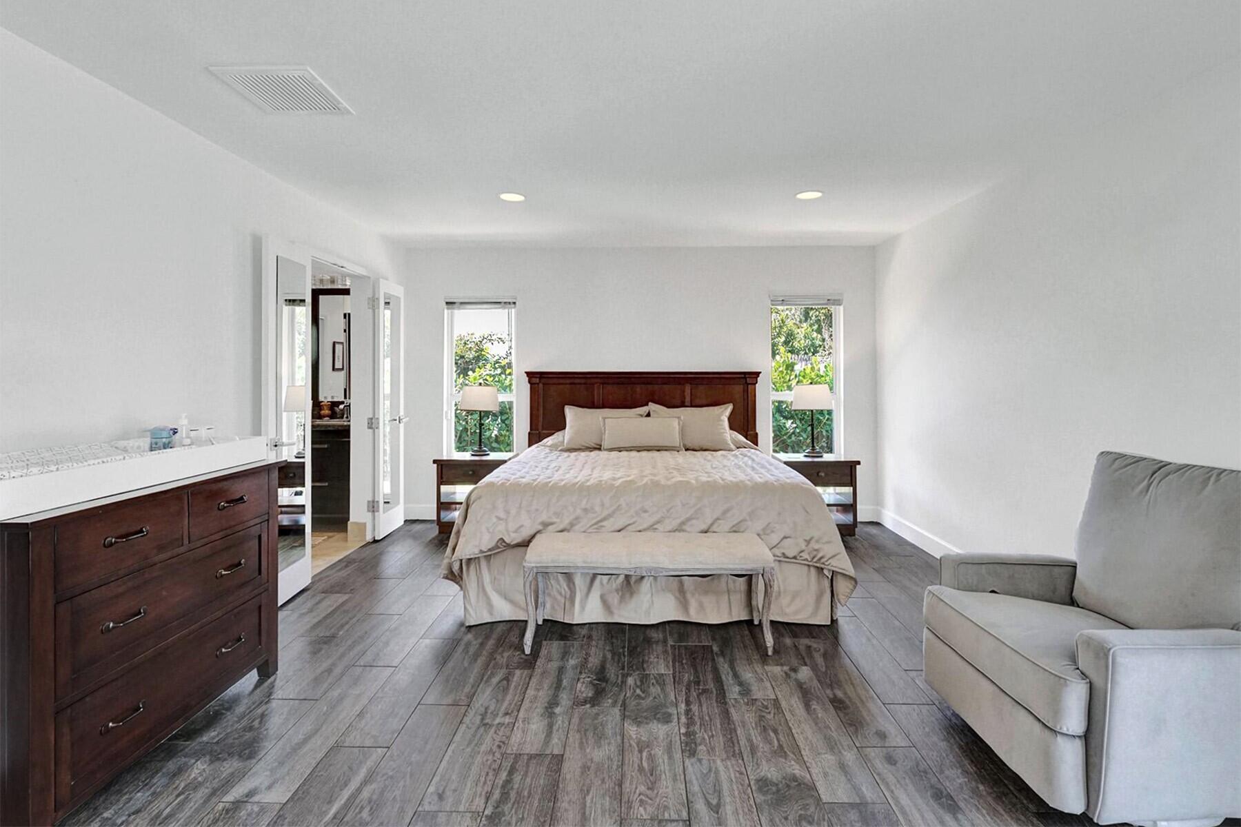 5264 Deerhurst Crescent Circle Boca Raton, FL 33486 - Photo 28 of 62 a bedroom with a large bed and a dresser