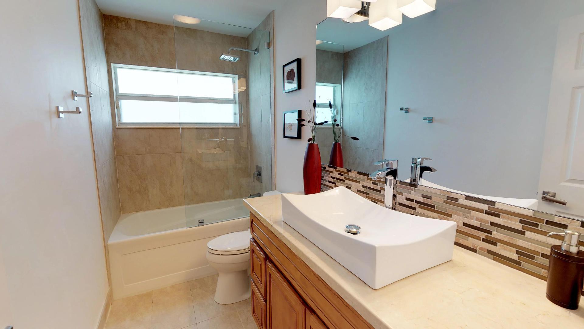 5264 Deerhurst Crescent Circle Boca Raton, FL 33486 - Photo 37 of 62 a bathroom with a sink a toilet and a bathtub
