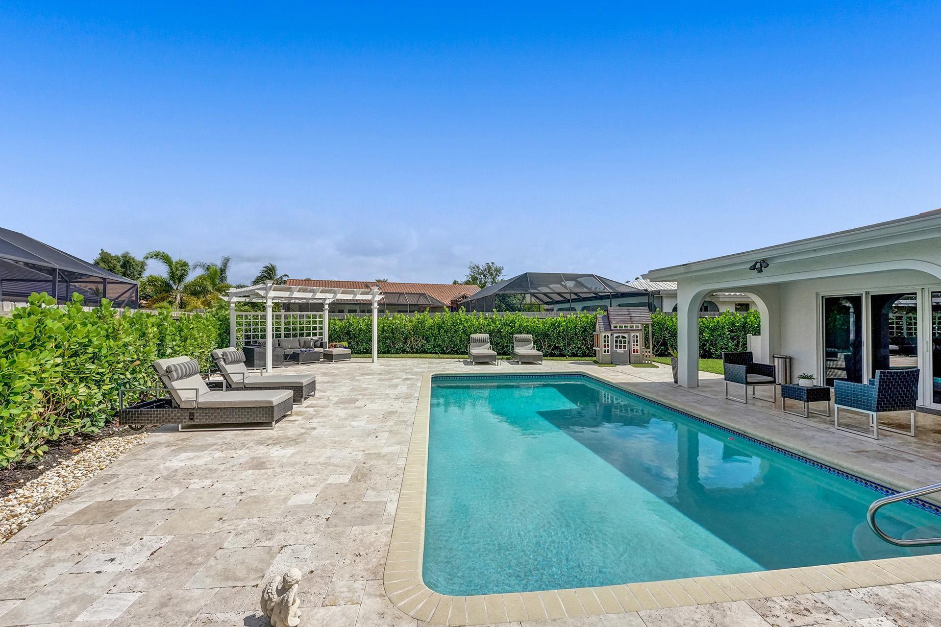 5264 Deerhurst Crescent Circle Boca Raton, FL 33486 - Photo 46 of 62 a view of a swimming pool with lounge chair
