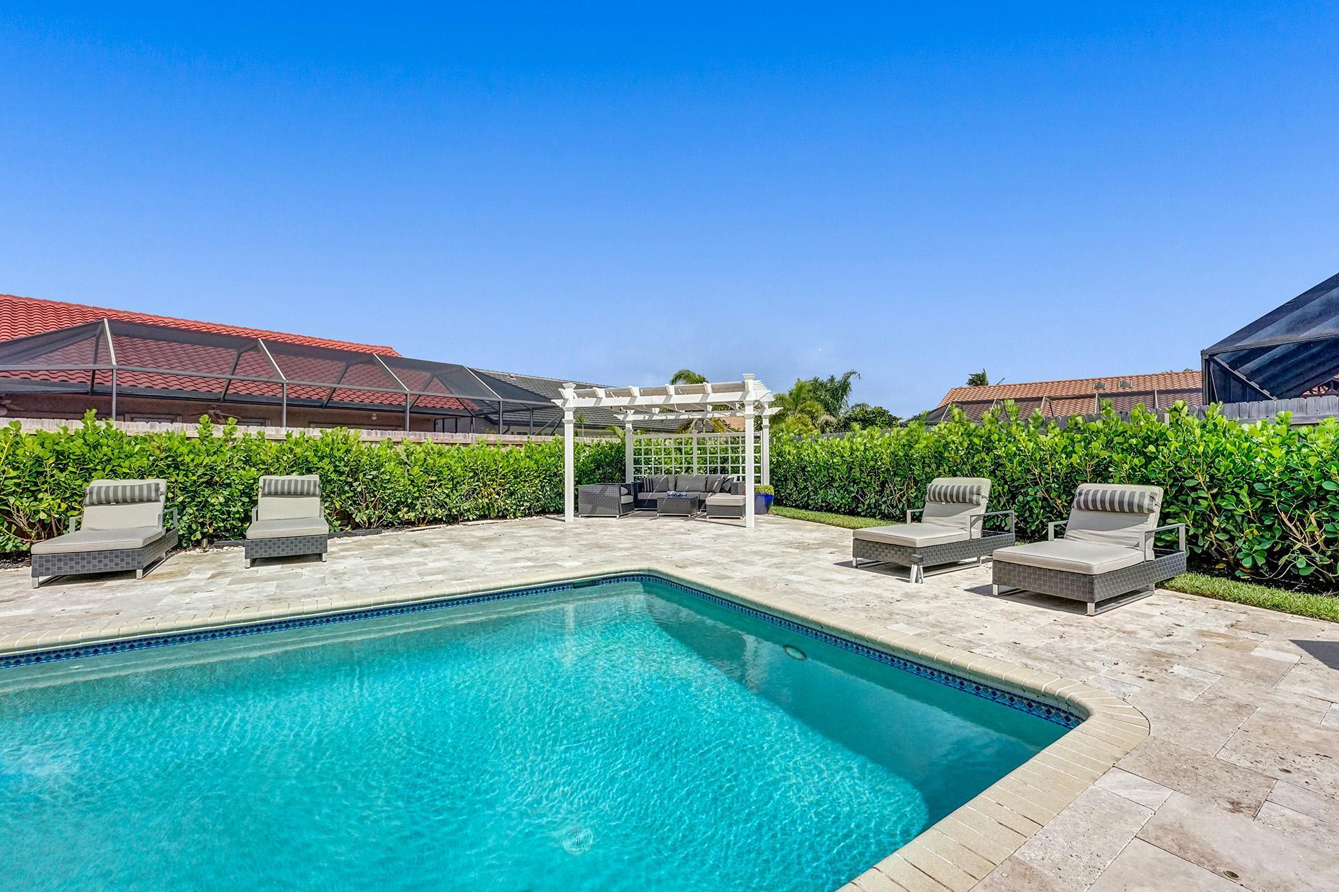 5264 Deerhurst Crescent Circle Boca Raton, FL 33486 - Photo 50 of 62 a view of swimming pool with outdoor seating and plants