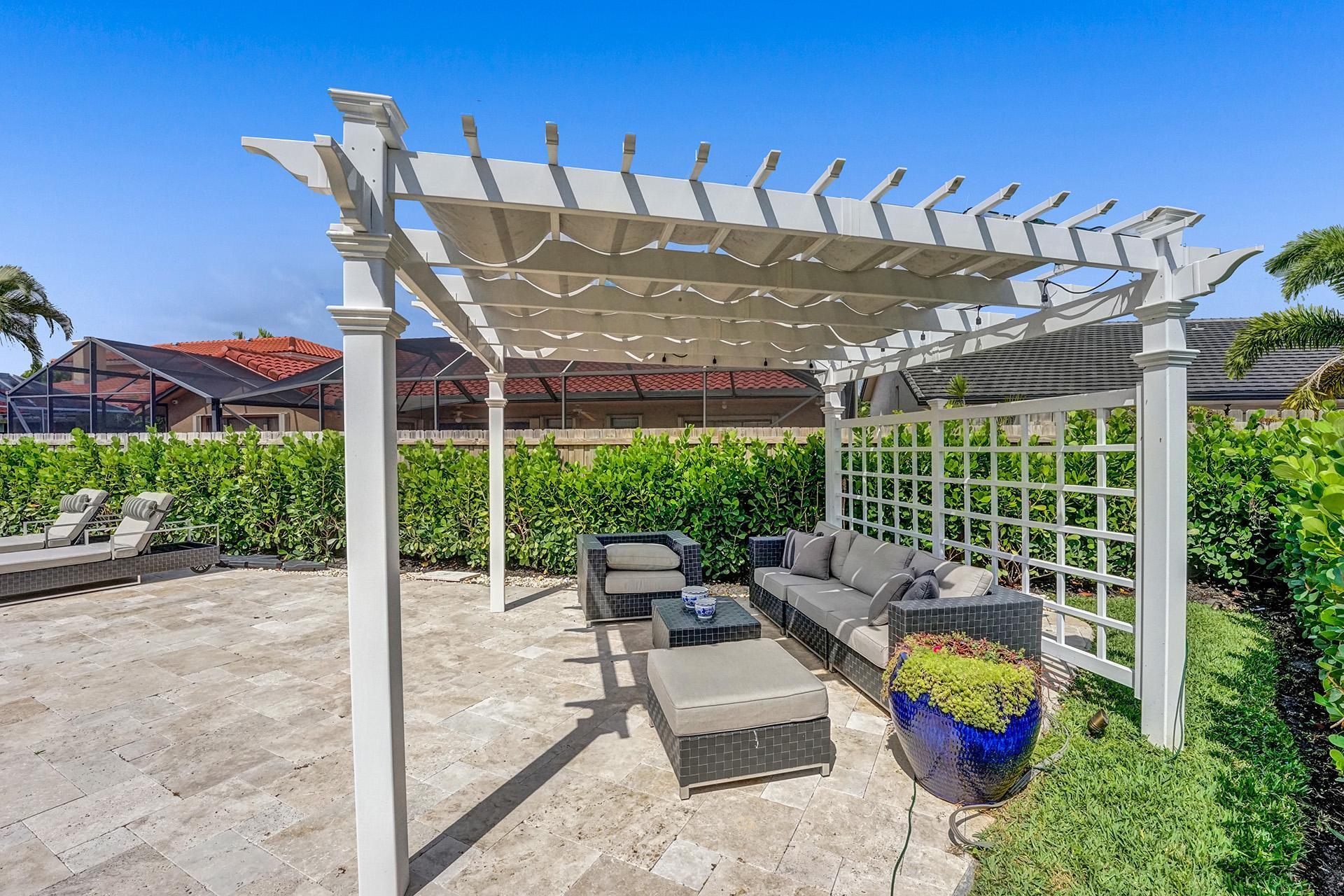 5264 Deerhurst Crescent Circle Boca Raton, FL 33486 - Photo 52 of 62 a view of a patio with couches table and chairs and potted plants