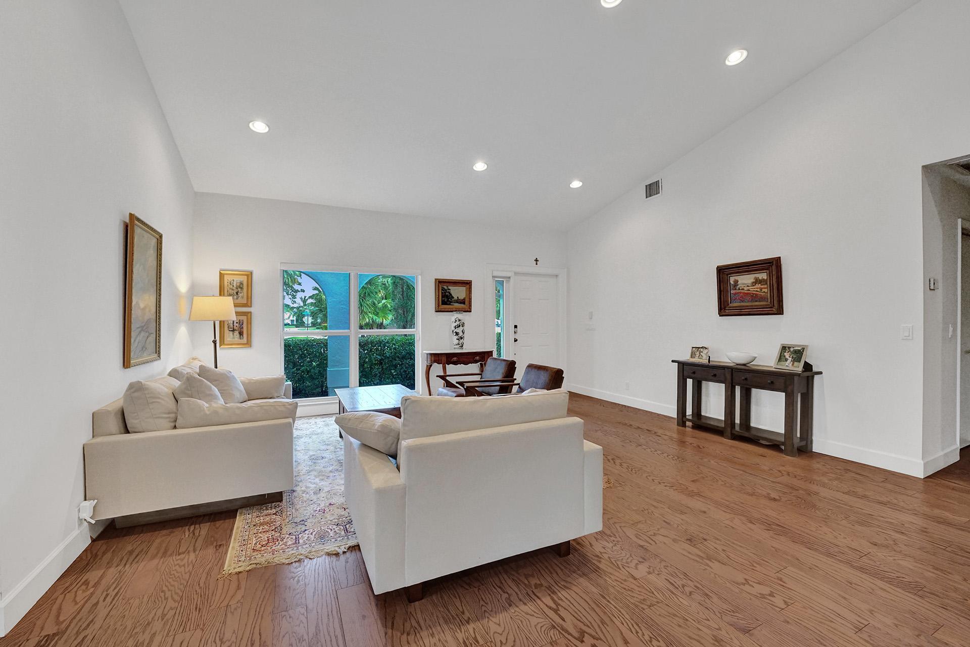5264 Deerhurst Crescent Circle Boca Raton, FL 33486 - Photo 8 of 62 a living room with furniture wooden floor and a large window