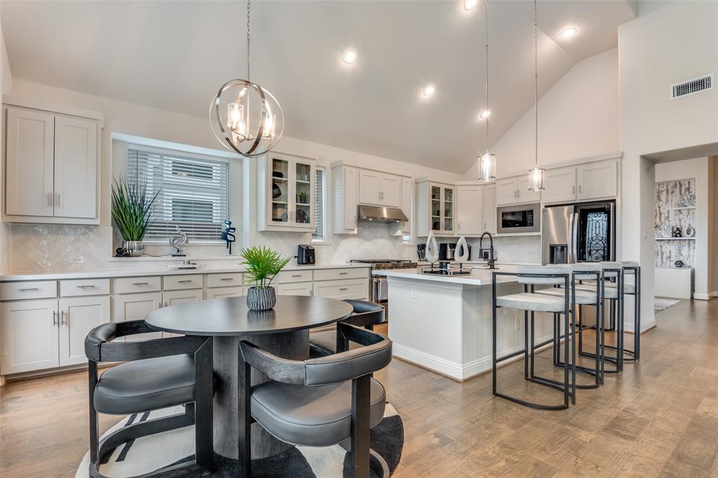 2417 Shane Drive Midlothian, TX 76065 - Photo 13 of 40 a kitchen with a dining table chairs sink and cabinets