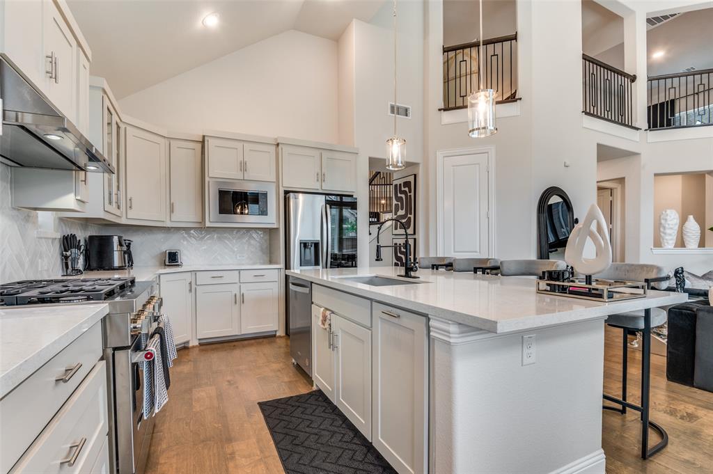 2417 Shane Drive Midlothian, TX 76065 - Photo 13 of 40 a kitchen with stainless steel appliances a sink stove refrigerator and cabinets