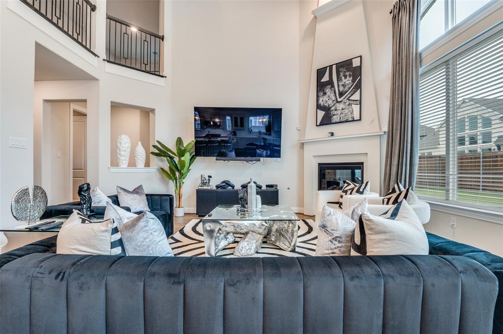 2417 Shane Drive Midlothian, TX 76065 - Photo 4 of 40 a living room with furniture a fireplace and a large window